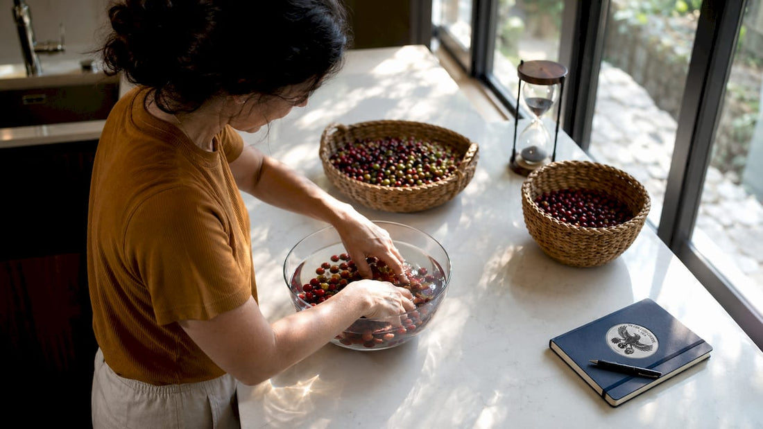 Woman washing coffee cherries in kitchen