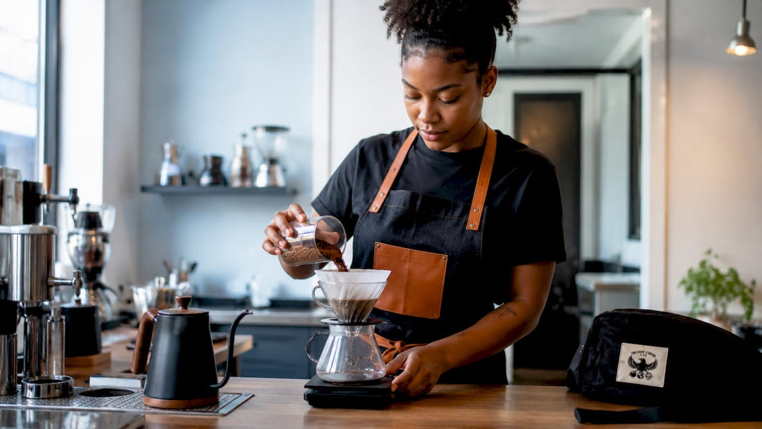 Woman brewing coffee at home kitchen